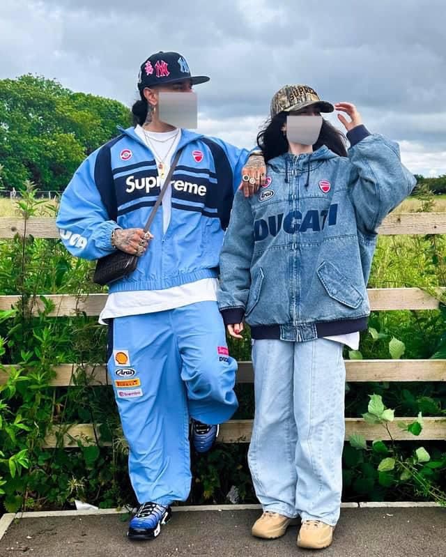 Man wearing light blue Supreme Ducati two-piece tracksuit outdoors.