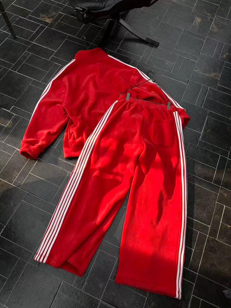 Red velour tracksuit set laid out showing back and side details.