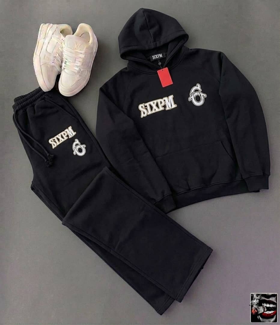 Black SIXPM embroidered hoodie and matching jogger pants with white sneakers.