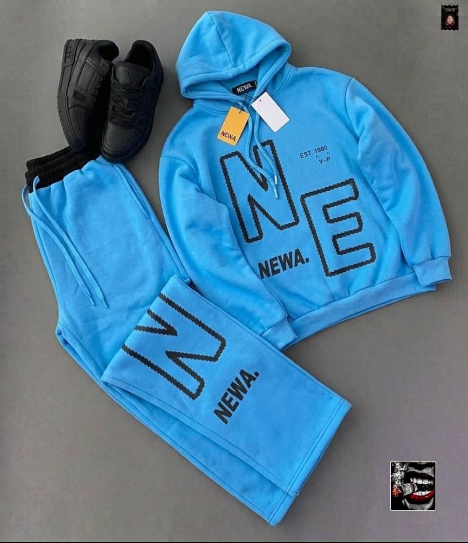 Bright blue NEWA letter hoodie and matching jogger pants with black sneakers.