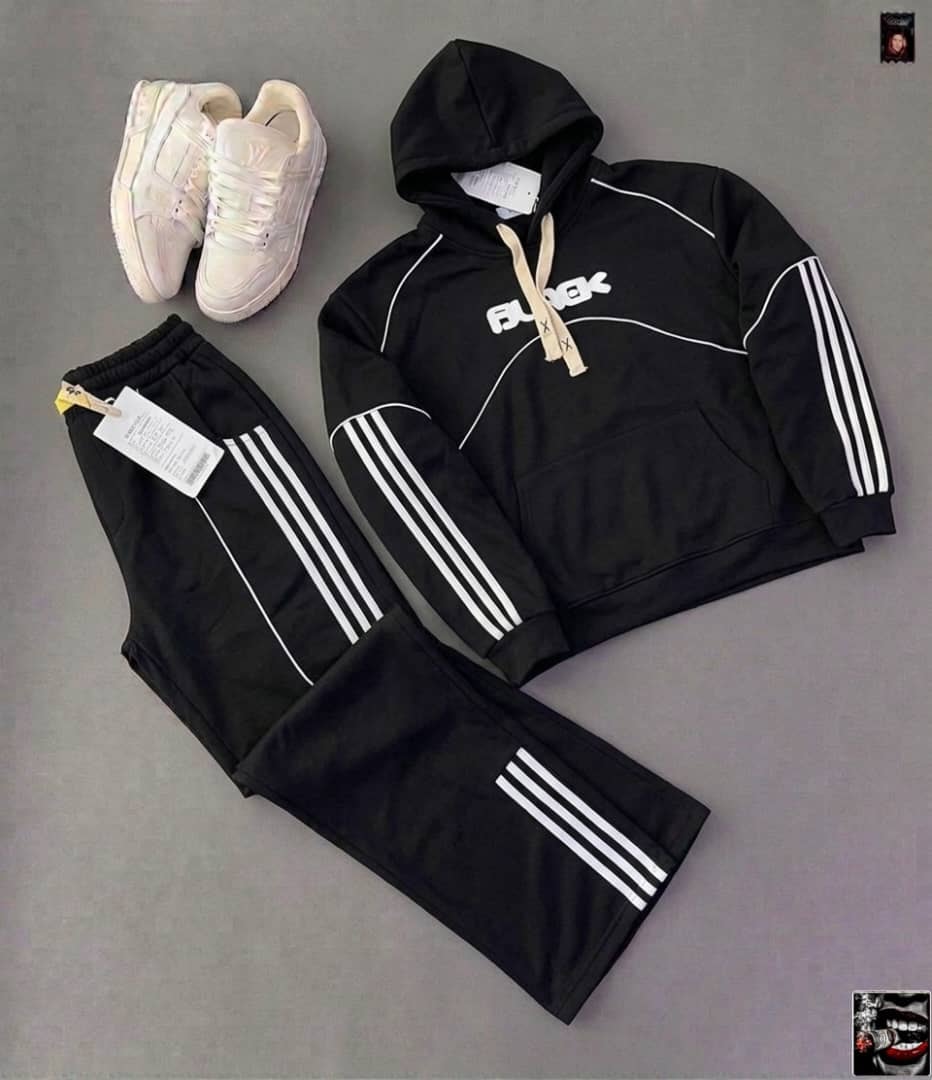 Black hoodie with white FLUX graphic, piping and stripes on sleeves with matching pants and iridescent sneakers.