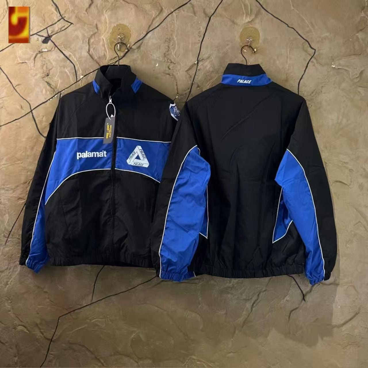Black and blue Palace track jacket front and back views.