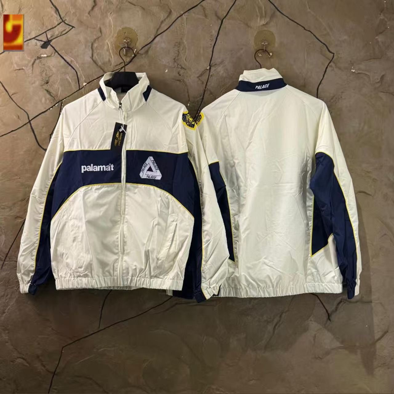 White and navy Palace track jacket front and back views.