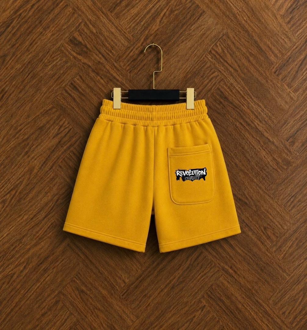 Back view of yellow fleece shorts with Revolution logo on pocket.