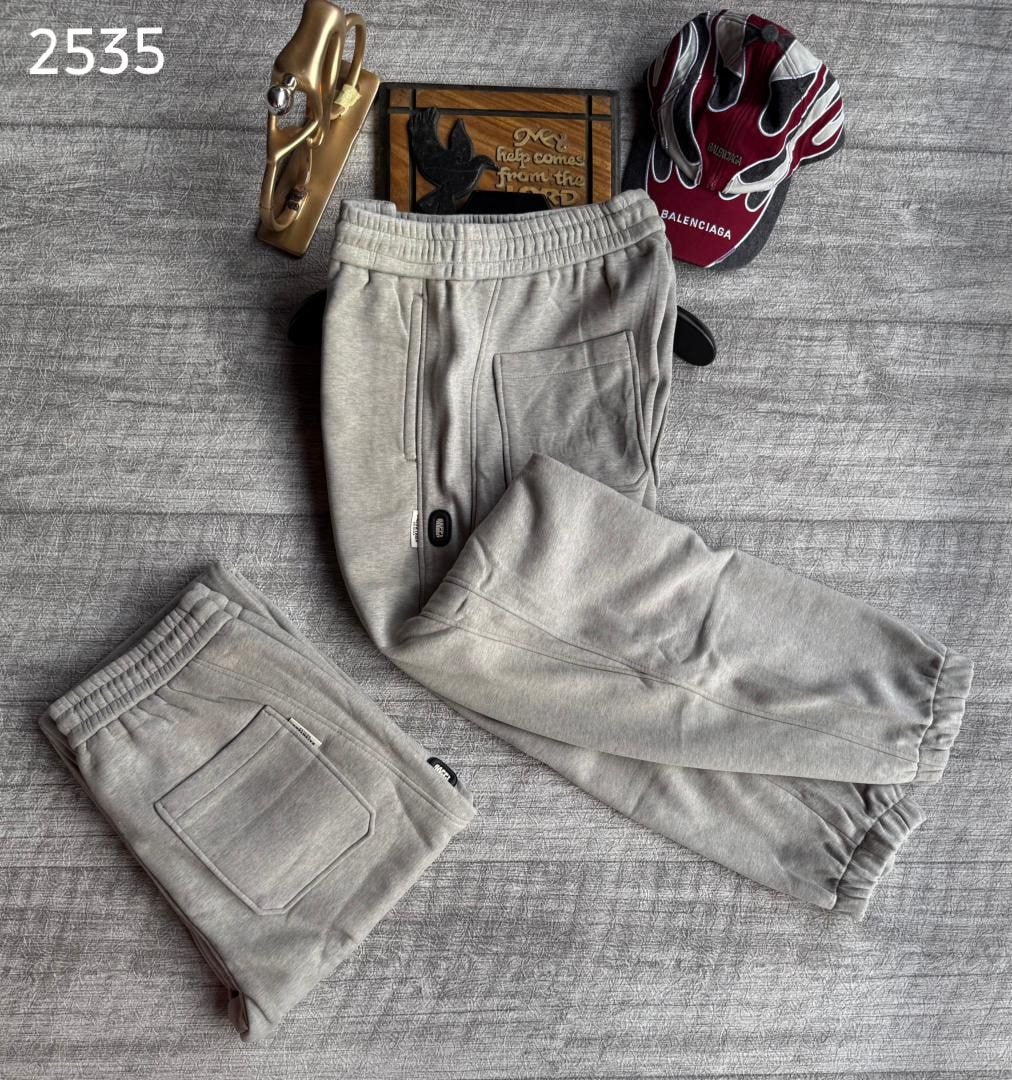 Gray joggers with small logos, shown in flat lay with front and folded back views.
