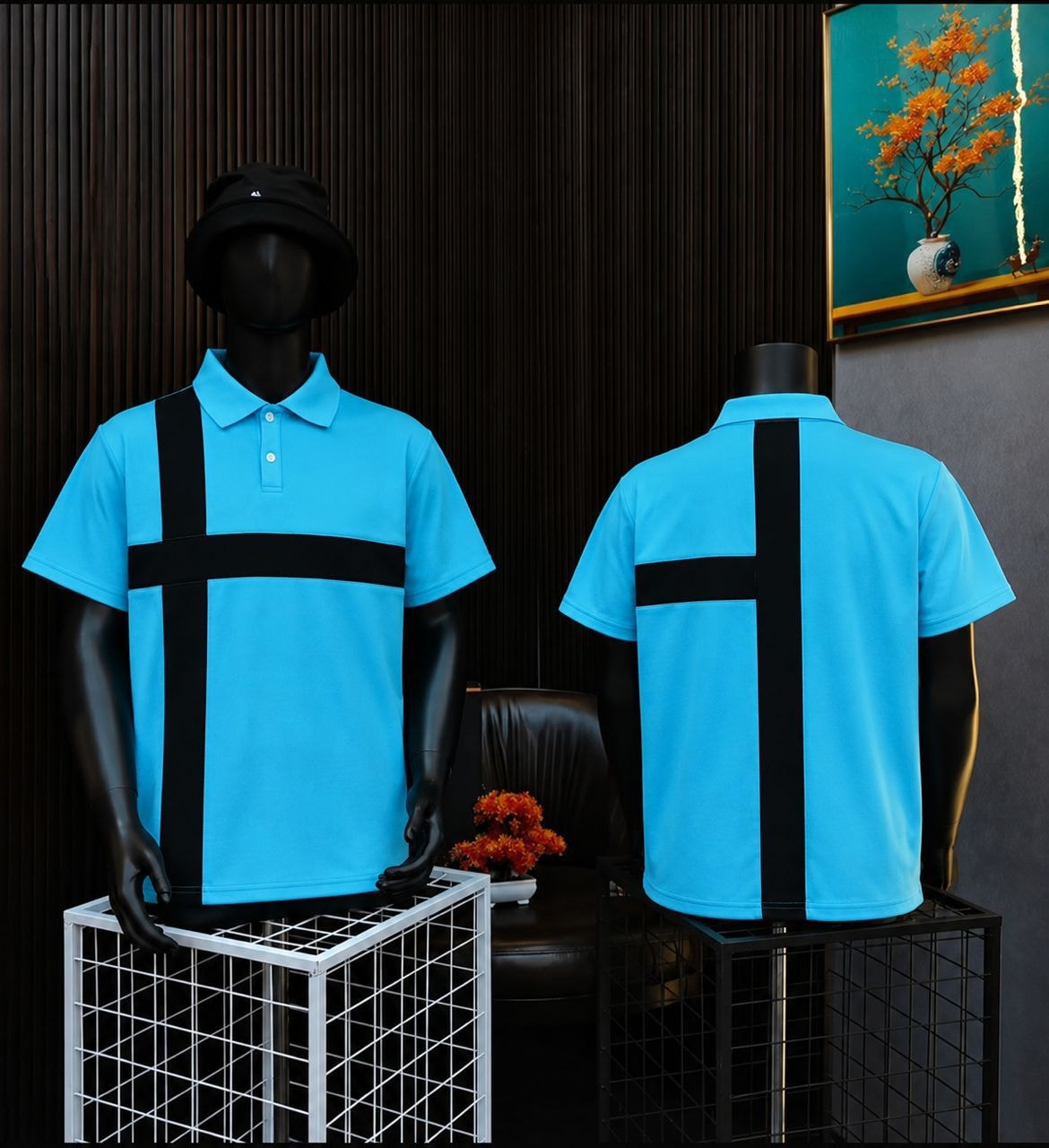 Blue polo shirt with black cross design on mannequin, front and back views.