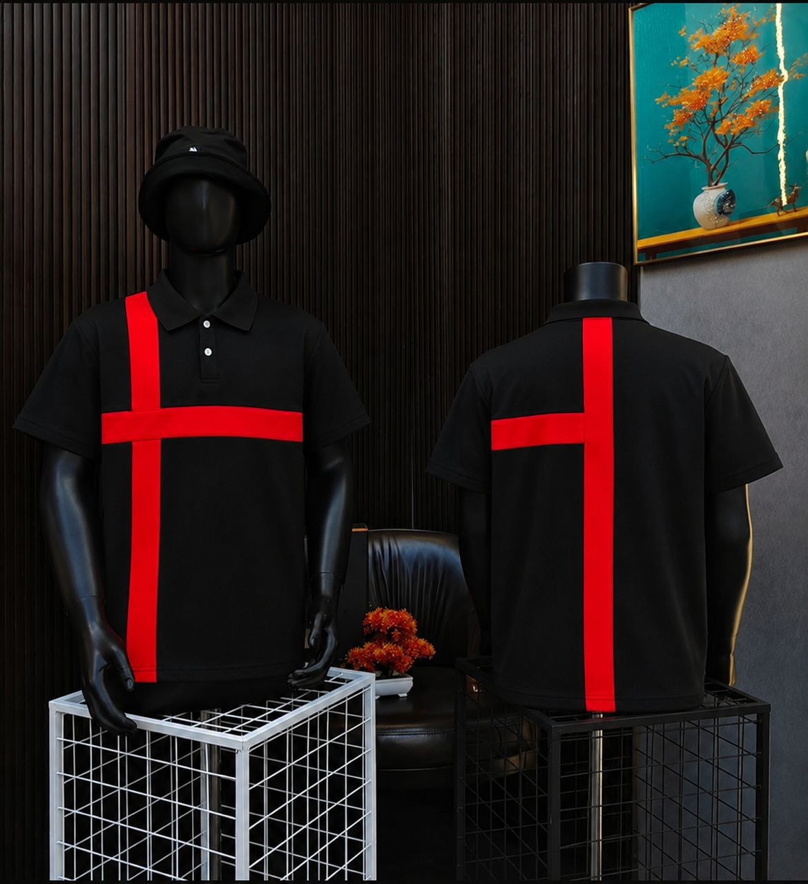Black polo shirt with red cross design on mannequin, front and back views.