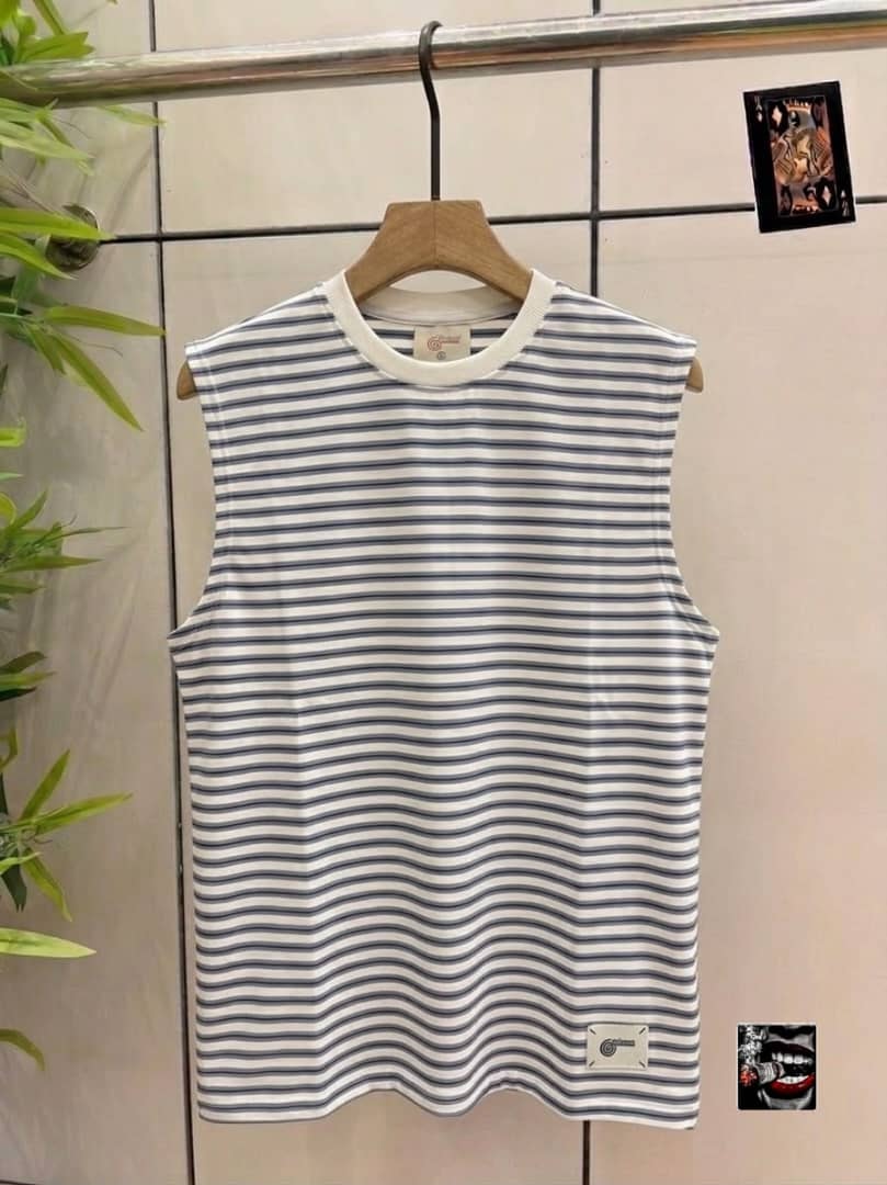 Gray and white striped sleeveless top with small hem tag.