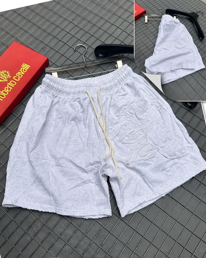 Light gray shorts with large embroidered horse graphic on the leg, on grid with red box and hangers.