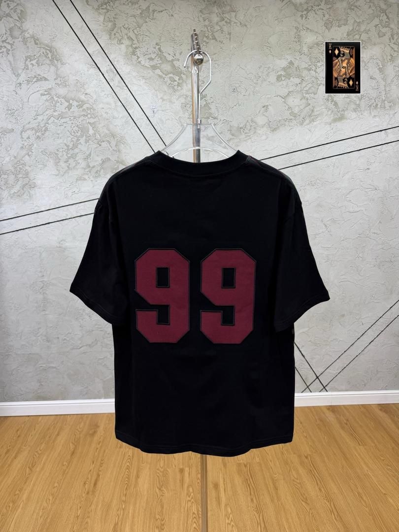 Black 99 numbered t-shirt back view hanging on stand.