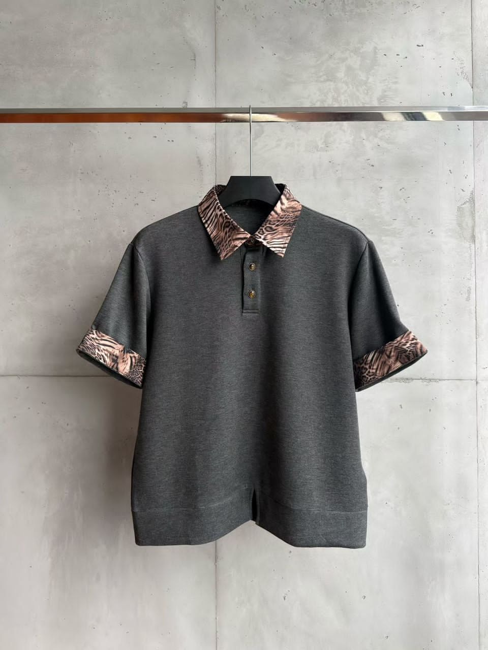 Gray short-sleeve polo shirt with animal print collar and cuffs.