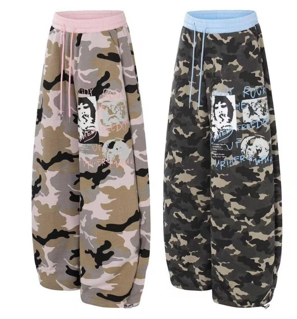 Beige camouflage and green camouflage joggers with graphic prints displayed side by side.