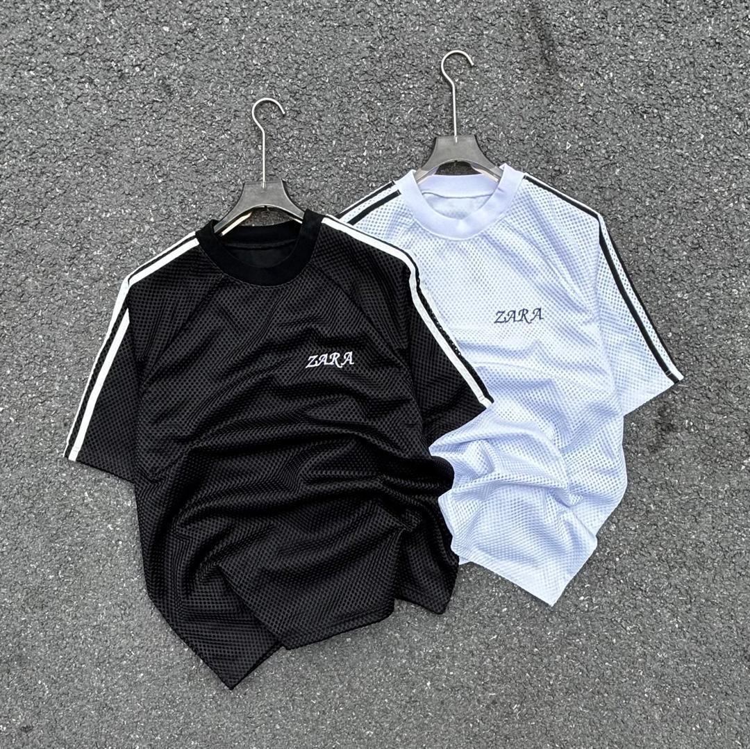 Black and white ZARA net mesh polo shirts with striped sleeves on pavement.