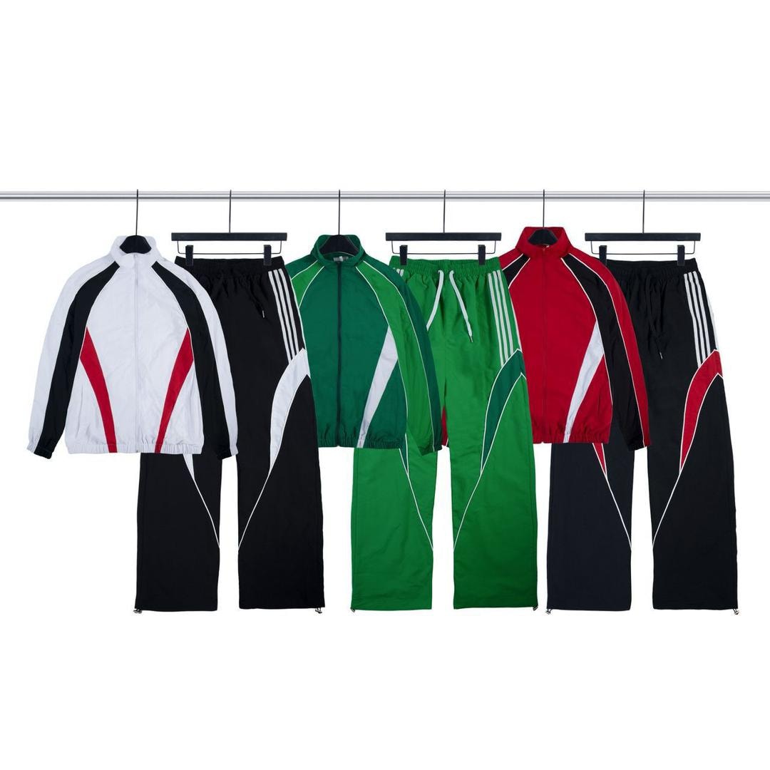 Multiple colorways of colorblock two-piece tracksuit sets hanging on rack.