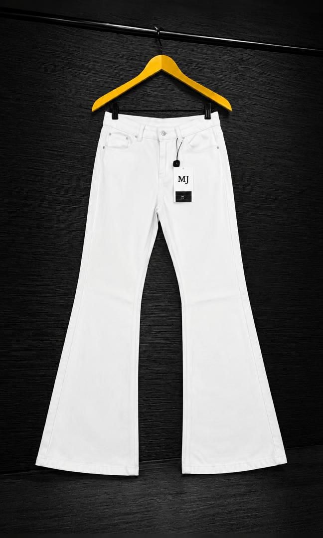 White flared jeans with MJ tag on wooden hanger against dark background.