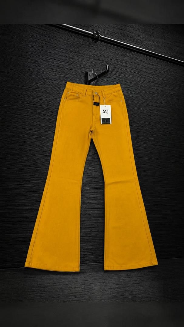 Yellow flared jeans with MJ tag displayed on black background.