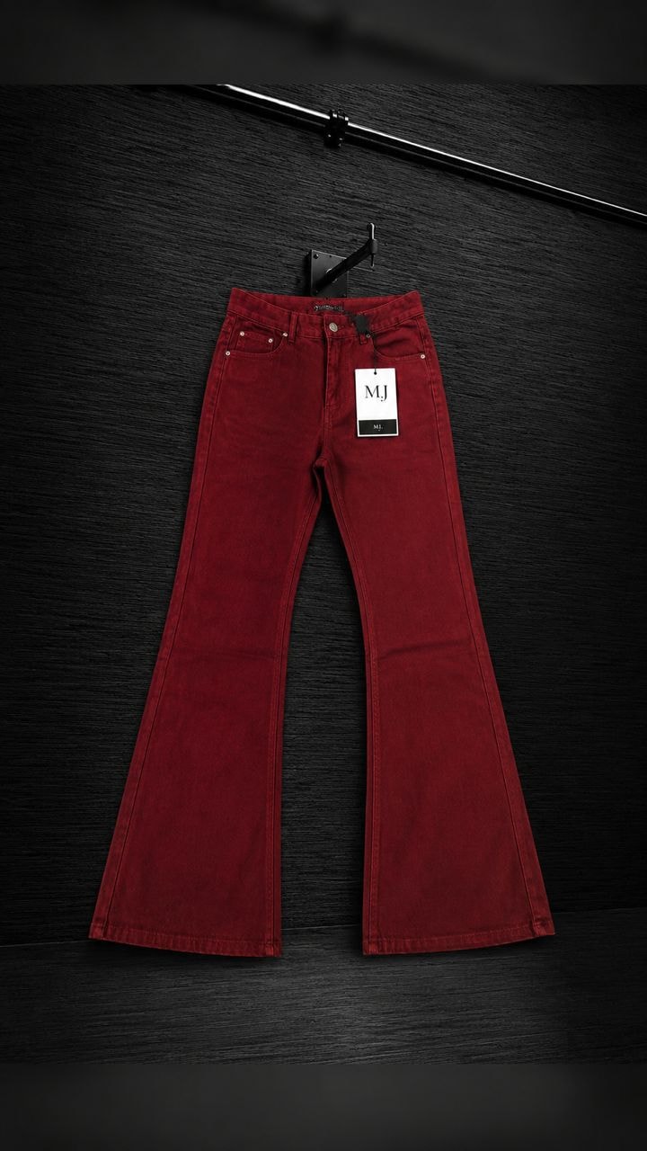 Burgundy flared jeans with MJ tag displayed on black background.