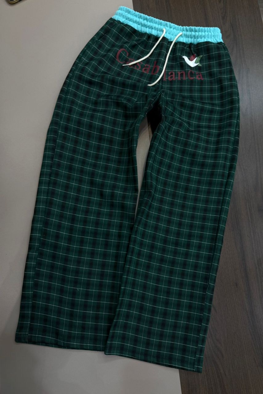 Green and black plaid joggers with Casablanca embroidery, bird logo and turquoise waistband.