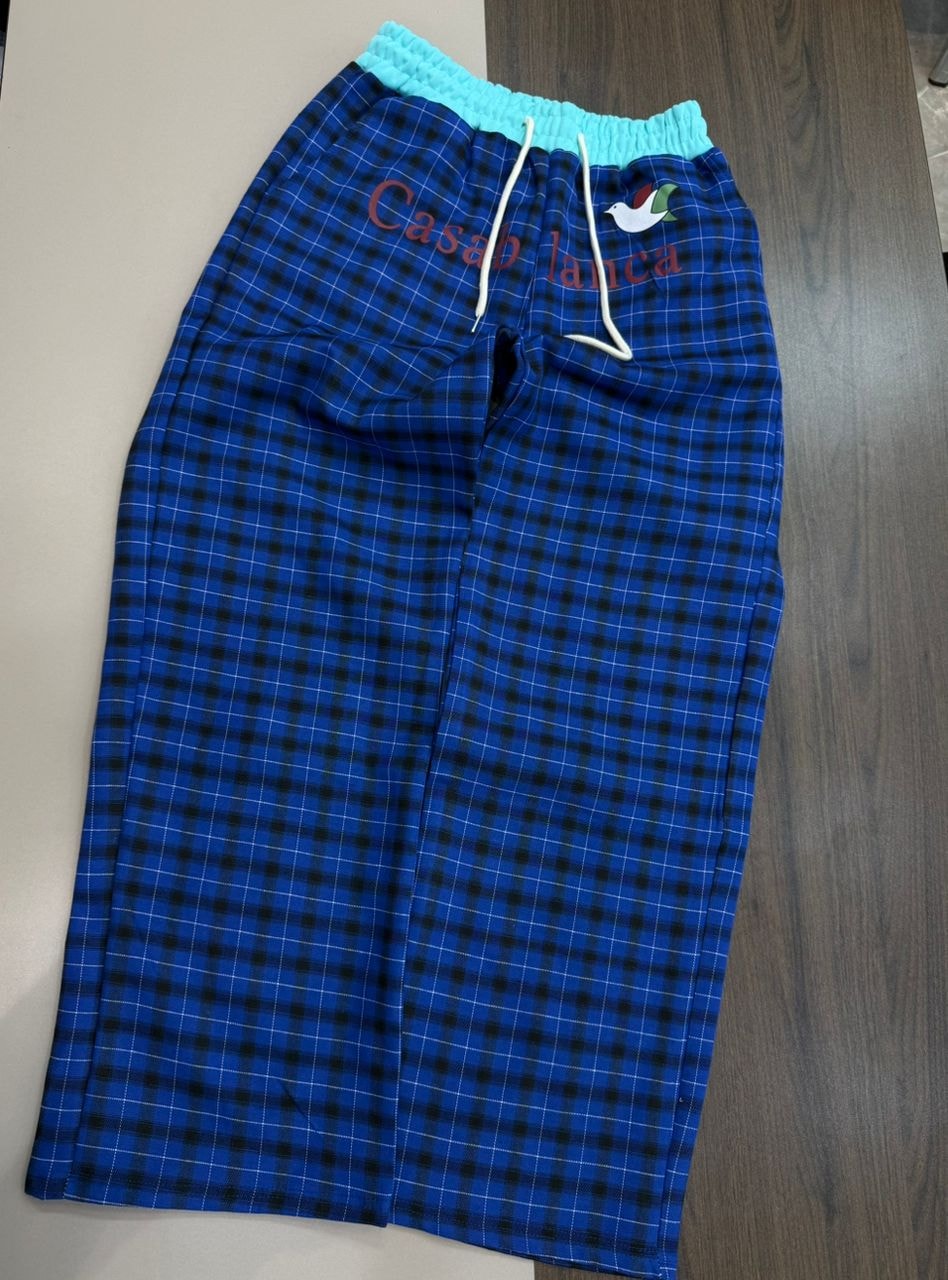 Blue and black plaid joggers with Casablanca embroidery, bird logo and turquoise waistband.