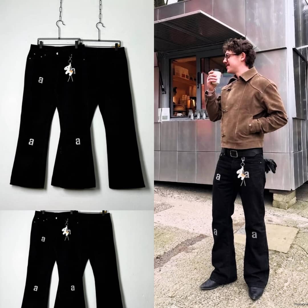 Black flared jeans with white A prints on legs and keychain detail, shown in studio and lifestyle.