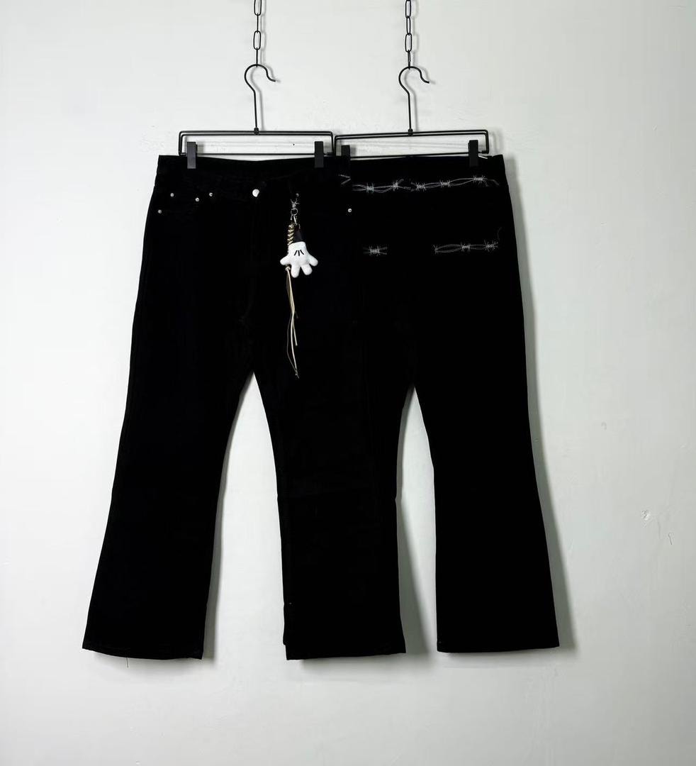 Black baggy jeans with white glove keychain and barbed wire embroidery on back.