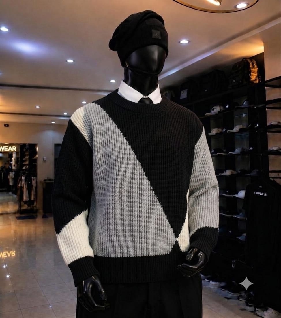 Mannequin wearing black gray and white colorblock knit sweatshirt with black beanie.