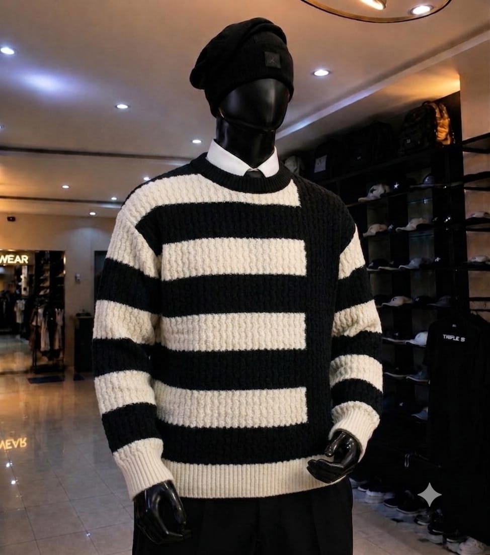 Mannequin wearing black and white striped chunky knit sweatshirt with black beanie.