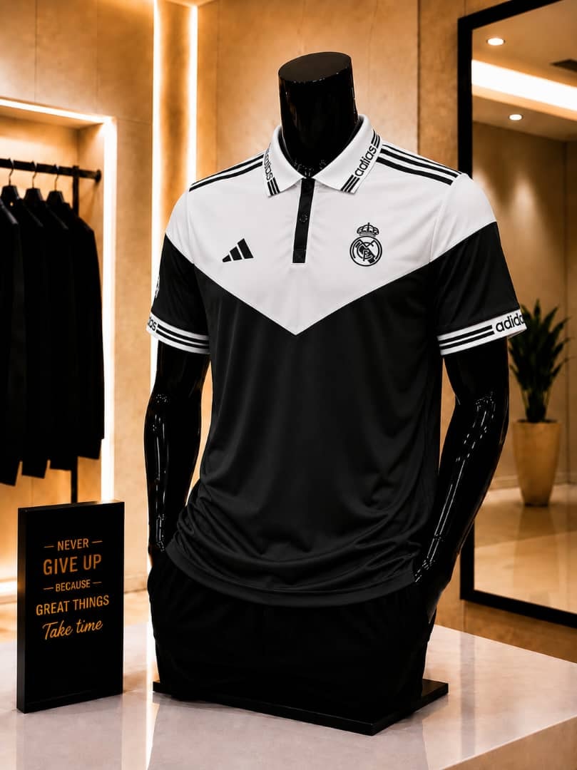Black and white Adidas Real Madrid polo football jersey on mannequin.