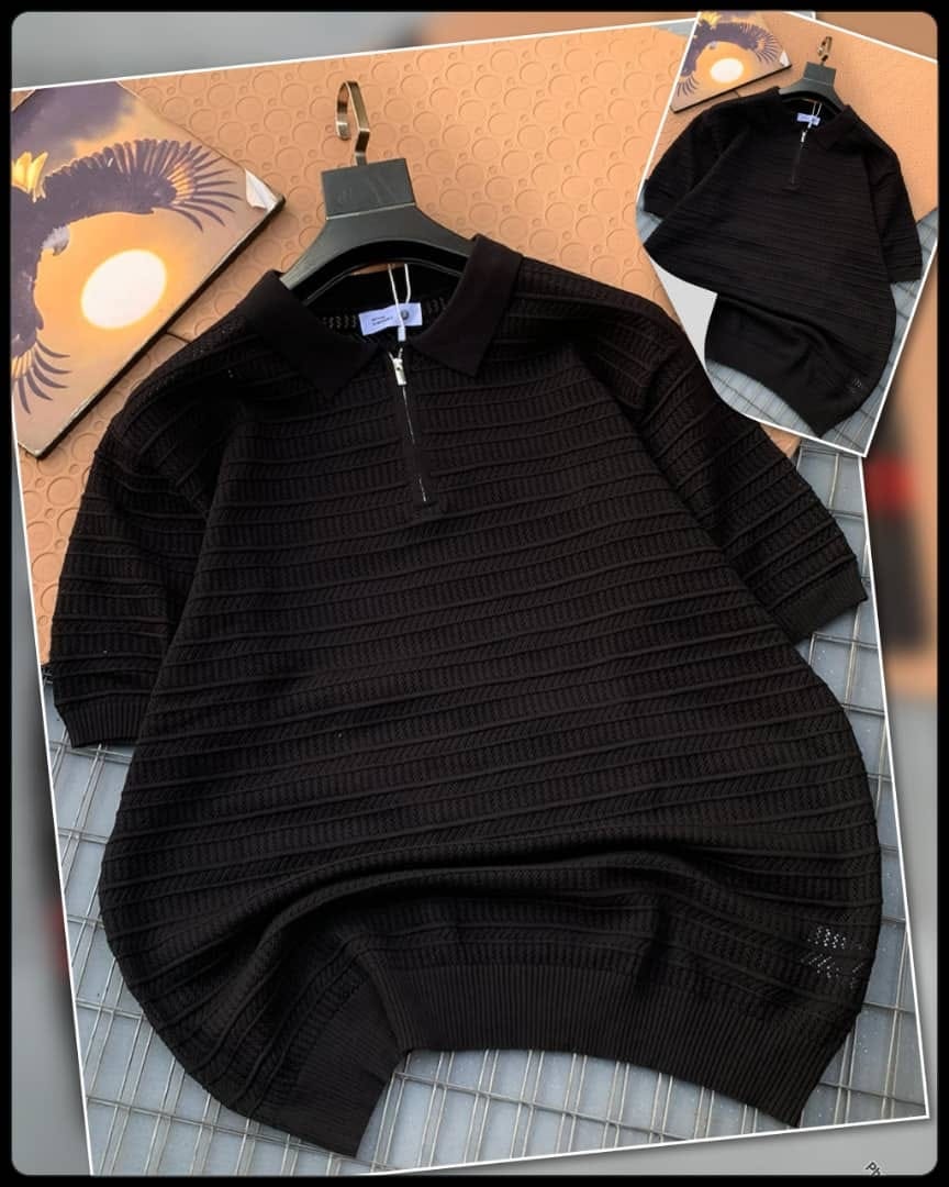 Black textured knitted zip polo shirt on hanger with inset.